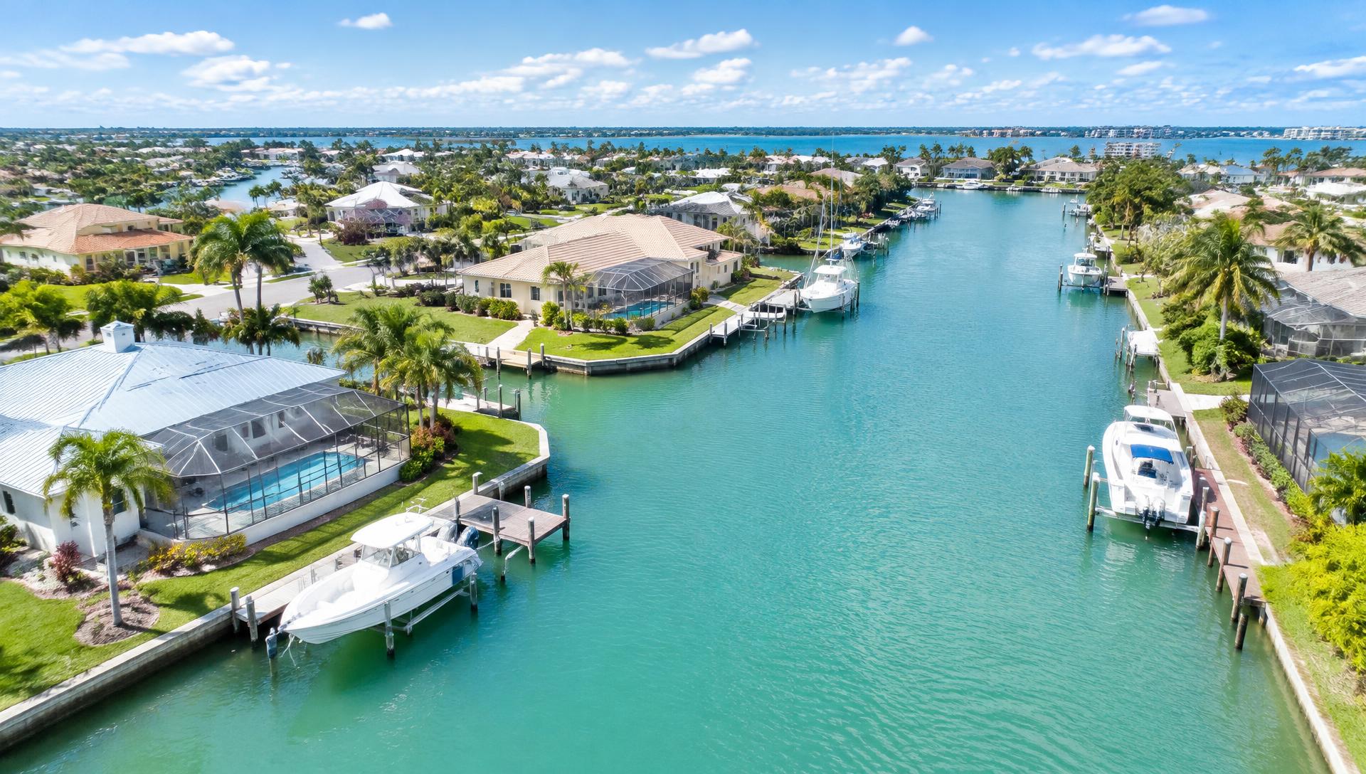Aerial view of Port Charlotte canal homes and boats on a sunny day